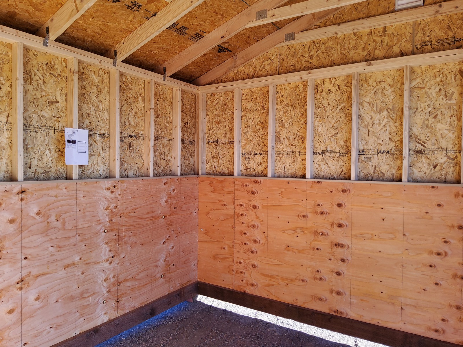 Interior kickboard wall detail inside a Colorado loafing shed for horses